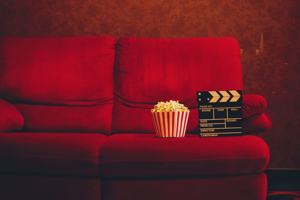 red sofa with popcorn in theater