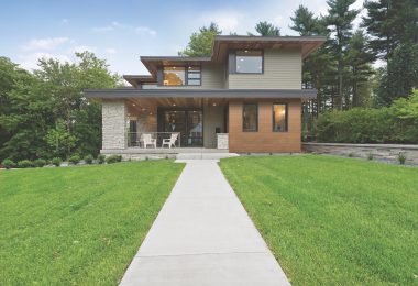 Long concrete sidewalk leading to the front door and porch area