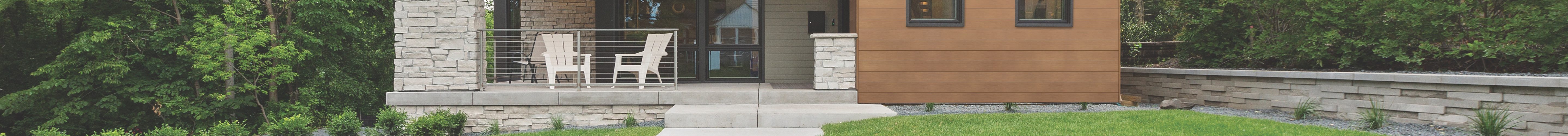 Long concrete sidewalk leading to the front door and porch area